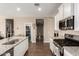 Modern kitchen with stainless steel appliances, granite countertops, and an open layout at 30089 W Rockmount Ave, Buckeye, AZ 85396