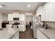 Bright and spacious kitchen featuring granite countertops, stainless steel appliances, and white cabinetry at 30089 W Rockmount Ave, Buckeye, AZ 85396