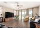 Open concept living room with tile floors, modern furniture, and patio access at 30089 W Rockmount Ave, Buckeye, AZ 85396