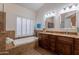 Bright bathroom featuring a soaking tub, dual sinks, and granite countertops at 31017 N 41St Pl, Cave Creek, AZ 85331