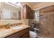 Well-lit bathroom with a granite vanity, tiled shower, and modern fixtures at 31017 N 41St Pl, Cave Creek, AZ 85331