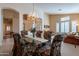 Elegant dining room featuring a chandelier and seating for six with glass table at 31017 N 41St Pl, Cave Creek, AZ 85331