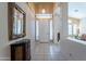 Inviting foyer with tiled floor, decor table, mirror, and natural light from front door windows at 31017 N 41St Pl, Cave Creek, AZ 85331