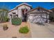 Charming single-story home with a two-car garage, desert landscaping, and an American flag at 31017 N 41St Pl, Cave Creek, AZ 85331