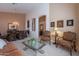 Bright living room with neutral carpet, ornate furniture, and an archway leading to the dining area at 31017 N 41St Pl, Cave Creek, AZ 85331