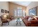 Bright living room area with a sofa, chairs, and large windows at 31017 N 41St Pl, Cave Creek, AZ 85331