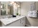 Bathroom featuring dual sinks, granite countertops, modern fixtures, and a separate shower at 4316 E Janice Way, Phoenix, AZ 85032