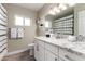 Bright bathroom featuring granite countertops, modern fixtures, and a shower/tub combo at 4316 E Janice Way, Phoenix, AZ 85032