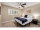 Neutral bedroom featuring a ceiling fan, window shutters, and simple decor at 4316 E Janice Way, Phoenix, AZ 85032