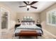 Relaxing bedroom features a ceiling fan, comfortable bed and plantation shutters for privacy at 4316 E Janice Way, Phoenix, AZ 85032