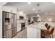 Open-concept kitchen with stainless steel appliances, granite countertops, and island seating at 4316 E Janice Way, Phoenix, AZ 85032