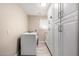 Spacious laundry room featuring white cabinets and a washer/dryer at 4316 E Janice Way, Phoenix, AZ 85032