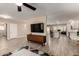 Bright open-concept living space with wood look tile floors extending into the kitchen at 4316 E Janice Way, Phoenix, AZ 85032