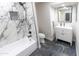 Bright bathroom features a bathtub with marble accents, a toilet, and modern vanity at 4609 E Adobe Dr, Phoenix, AZ 85050