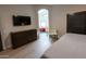 Primary bedroom with luxury vinyl flooring, custom dresser, and open en-suite bathroom at 4609 E Adobe Dr, Phoenix, AZ 85050