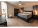 Primary bedroom featuring luxury vinyl floors, a spacious closet, and custom window coverings at 4609 E Adobe Dr, Phoenix, AZ 85050
