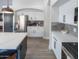 View of kitchen with white cabinetry, stainless steel refrigerator, and marble countertops at 4609 E Adobe Dr, Phoenix, AZ 85050