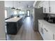 Modern kitchen features a large island, stainless steel appliances, and sleek white cabinets at 4609 E Adobe Dr, Phoenix, AZ 85050