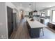 Modern kitchen with a central island, stainless steel appliances, and white cabinets at 4609 E Adobe Dr, Phoenix, AZ 85050