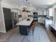 Bright, updated kitchen with a large island, stainless steel appliances, and stylish pendant lighting at 4609 E Adobe Dr, Phoenix, AZ 85050