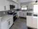 Bright kitchen with stainless steel appliances, white cabinetry, and marble backsplash at 4609 E Adobe Dr, Phoenix, AZ 85050