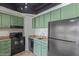 Kitchen featuring black appliances and green cabinets with granite countertops at 4750 N Central Ave # G3, Phoenix, AZ 85012