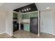 Kitchen with green cabinets, black appliances, granite counters, and tile floors at 4750 N Central Ave # G3, Phoenix, AZ 85012
