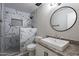 Bathroom features marble tiling, a decorative mirror, and granite countertops at 4950 N Miller Rd # 233, Scottsdale, AZ 85251