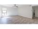 Spacious bedroom with wood floors, a modern ceiling fan, and a bright window at 4950 N Miller Rd # 233, Scottsdale, AZ 85251