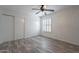 This bedroom features light walls and flooring and a ceiling fan at 4950 N Miller Rd # 233, Scottsdale, AZ 85251