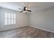 A cozy bedroom with wood floors, a ceiling fan, and a window at 4950 N Miller Rd # 233, Scottsdale, AZ 85251