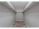 Walk-in closet features shelving on both sides and wood-look flooring at 4950 N Miller Rd # 233, Scottsdale, AZ 85251