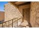 Exterior view of a condo entrance featuring a textured wall and covered entry on the second level at 4950 N Miller Rd # 233, Scottsdale, AZ 85251