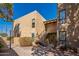 Charming condo exterior with stone facade, stairway, and desert landscaping under a clear blue sky at 4950 N Miller Rd # 233, Scottsdale, AZ 85251