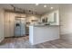 Stylish kitchen with white cabinets, stainless steel appliances, and an open breakfast bar at 4950 N Miller Rd # 233, Scottsdale, AZ 85251