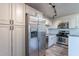 Contemporary kitchen featuring white cabinets, stainless steel appliances, and attractive backsplash at 4950 N Miller Rd # 233, Scottsdale, AZ 85251