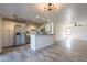 An open-concept kitchen and living room area with wood flooring and recessed lighting at 4950 N Miller Rd # 233, Scottsdale, AZ 85251