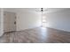 Bright, spacious living room featuring wood flooring, white walls, and a modern ceiling fan at 4950 N Miller Rd # 233, Scottsdale, AZ 85251
