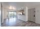 Inviting living area with wood flooring, a kitchen view, and a sliding glass door to the balcony at 4950 N Miller Rd # 233, Scottsdale, AZ 85251