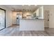 Open living space featuring a stylish kitchen with stainless steel appliances and a sliding glass door at 4950 N Miller Rd # 233, Scottsdale, AZ 85251