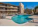 Community pool features several chairs for residents to lounge at 4950 N Miller Rd # 233, Scottsdale, AZ 85251