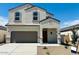 Charming two-story home featuring a neutral color palette, arched windows, and a spacious two-car garage at 5058 E Umber Rd, San Tan Valley, AZ 85143