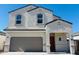 Charming two-story home featuring a stucco exterior, a gray tile roof, and an attached two-car garage at 5058 E Umber Rd, San Tan Valley, AZ 85143