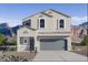 Two-story home with a two car garage, neutral color palette, and desert landscaping at 5058 E Umber Rd, San Tan Valley, AZ 85143