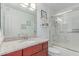 Bathroom featuring a wood vanity, granite countertop, and shower and tub with glass doors at 5104 N 32Nd St # 144, Phoenix, AZ 85018