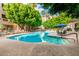 Community pool with lounge chairs, tables, and lush landscaping at 5104 N 32Nd St # 144, Phoenix, AZ 85018