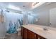 Neutral bathroom with modern vanity, white countertop, and cactus shower curtain at 5305 E Silverbell Rd, San Tan Valley, AZ 85143