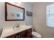 Bathroom featuring wood vanity, white sink, and decorative framed wall art at 5305 E Silverbell Rd, San Tan Valley, AZ 85143