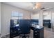 Office bedroom with large window, dark desk, and mirrored closet doors at 5305 E Silverbell Rd, San Tan Valley, AZ 85143