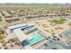 Aerial view of the community pool, parking, and surrounding neighborhood at 5305 E Silverbell Rd, San Tan Valley, AZ 85143